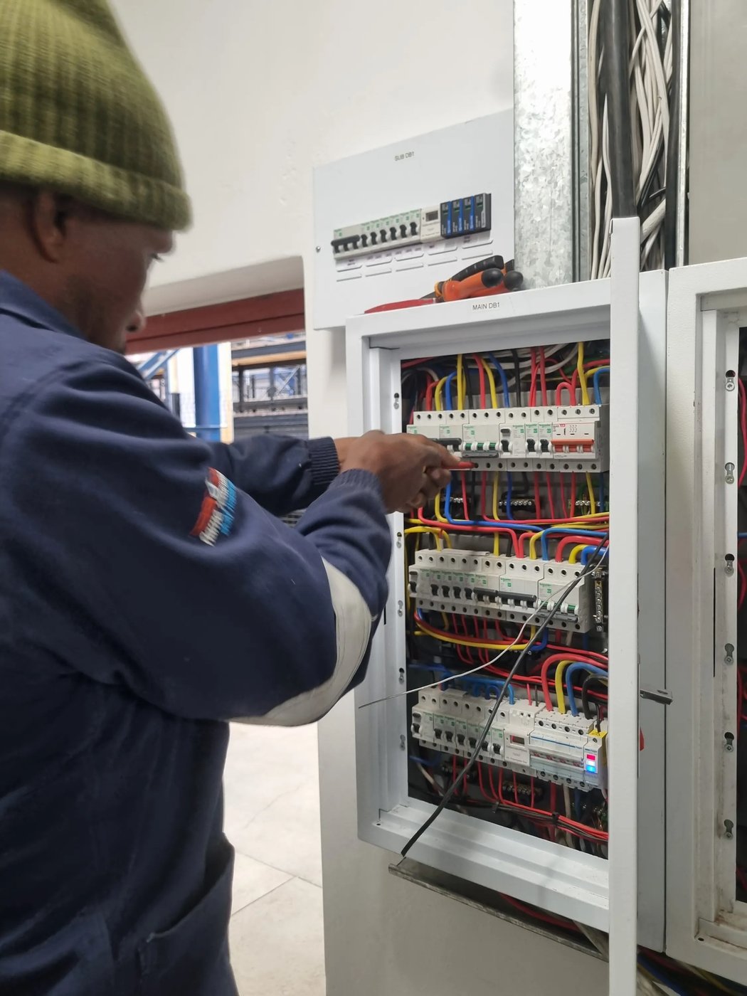 Sputnik Energy electrician wiring a new distribution board on-site